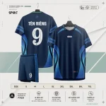 Áo bóng đá không logo ARES Spirit – nền xanh navy đậm, dải xanh dương gradient uốn cong từ vai xuống sườn đối xứng hai bên thân áo, ba sọc xanh dương ngang trên tay áo, cổ V-neck phối navy, mặt lưng in tên riêng và số 9 trắng nổi bật, quần navy phối sọc xanh dương dọc bên cạnh và số 9 trắng, palette navy xanh dương mang khí thế đại dương sâu thẳm và đầy nội lực.